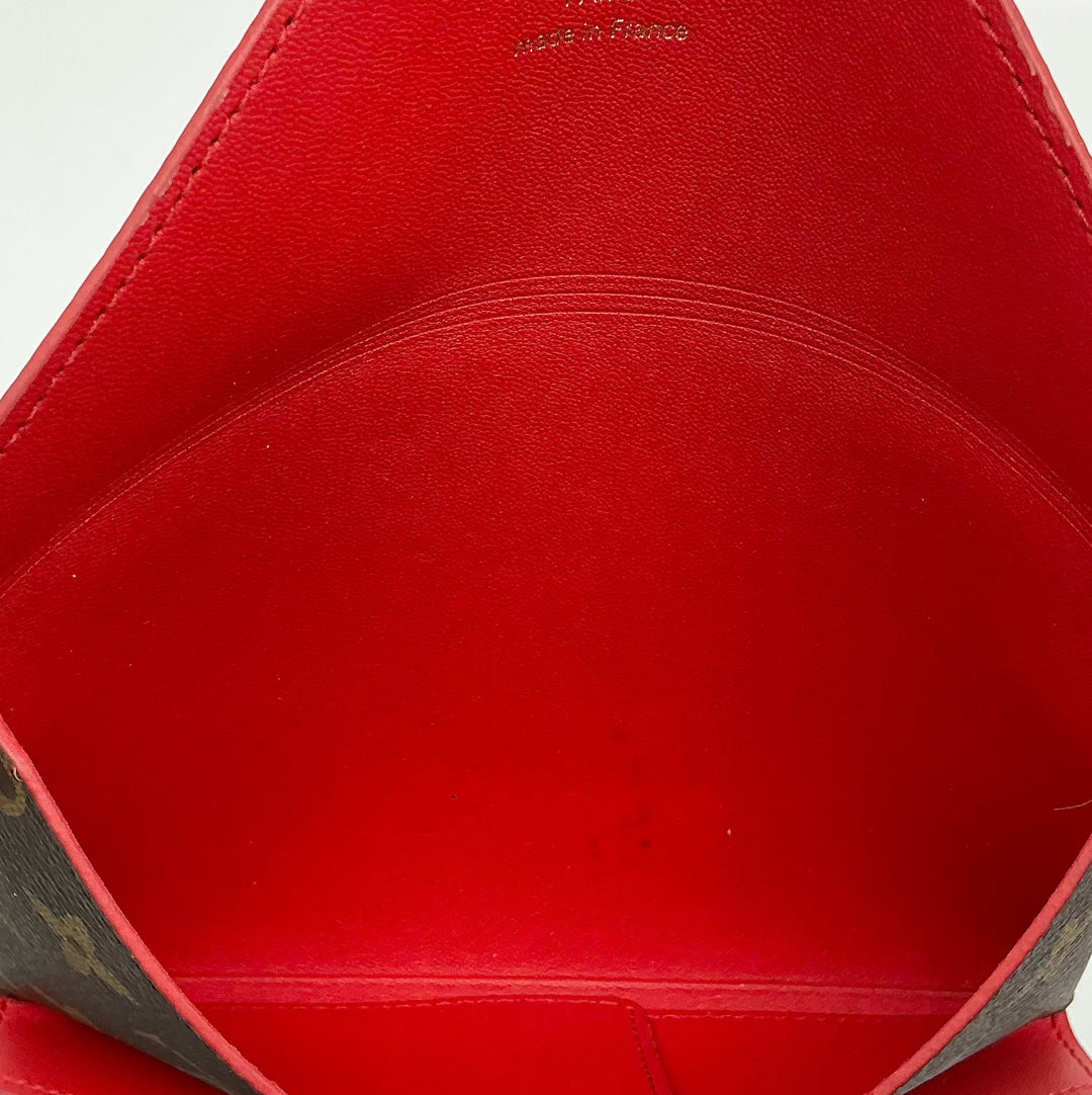 Interior view of Louis Vuitton Medium Kirigami Pochette Insert showcasing vibrant red leather finish.