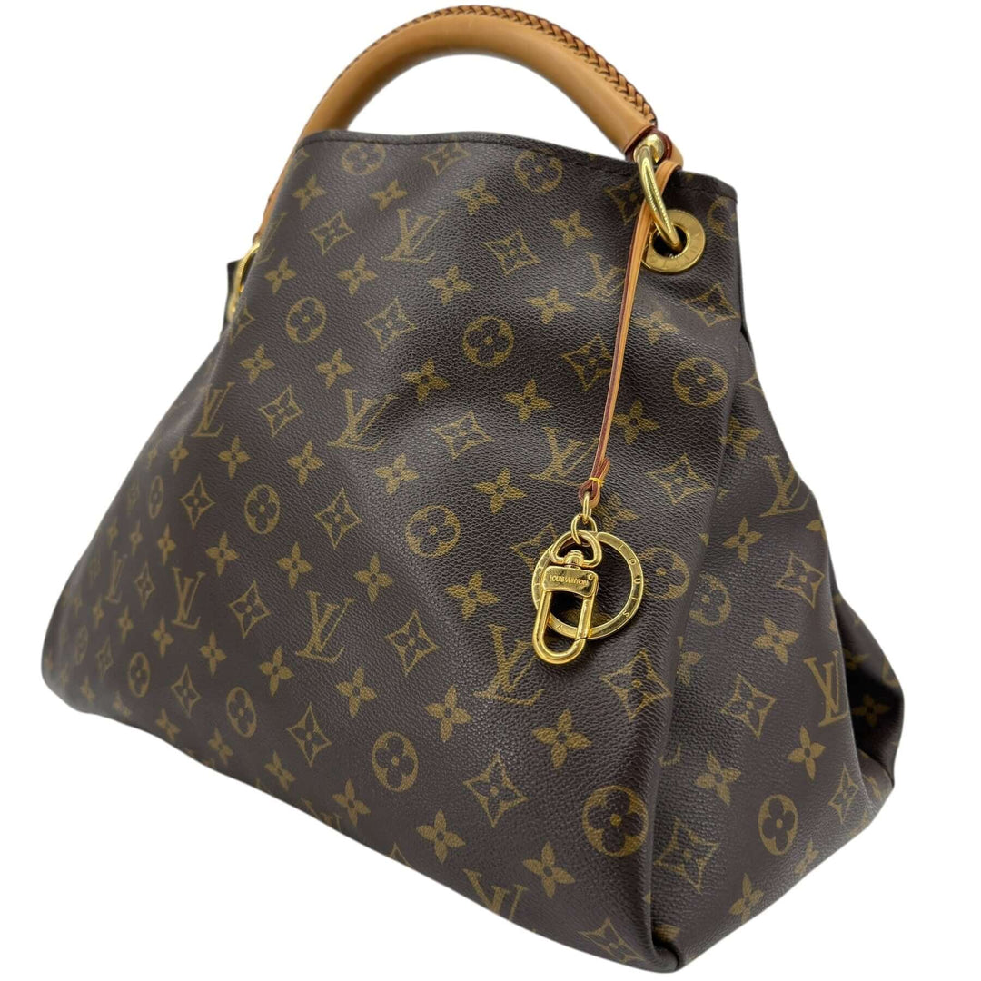 Louis Vuitton Monogram Artsy MM Shoulder Bag Brown side view showcasing the iconic design and vachetta handle.