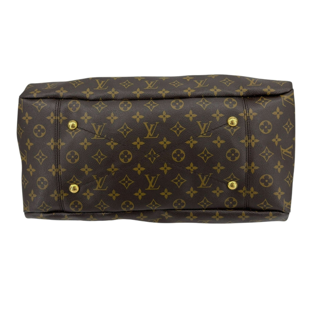 Louis Vuitton Monogram Artsy MM Shoulder Bag Brown bottom view showcasing gold-tone hardware and iconic monogram pattern.