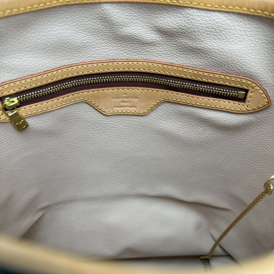 Interior view of Louis Vuitton Monogram Bucket Bag showing zippered pocket and soft lining.