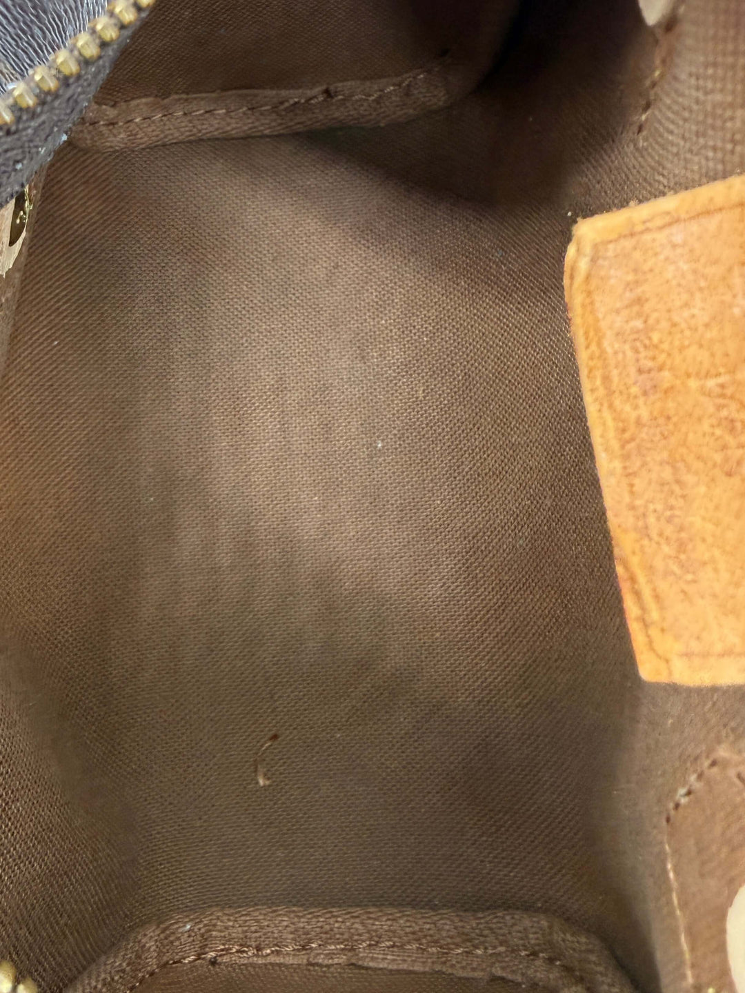 Interior view of Louis Vuitton Mini HL Speedy handbag, showcasing rich fabric lining and craftsmanship details.