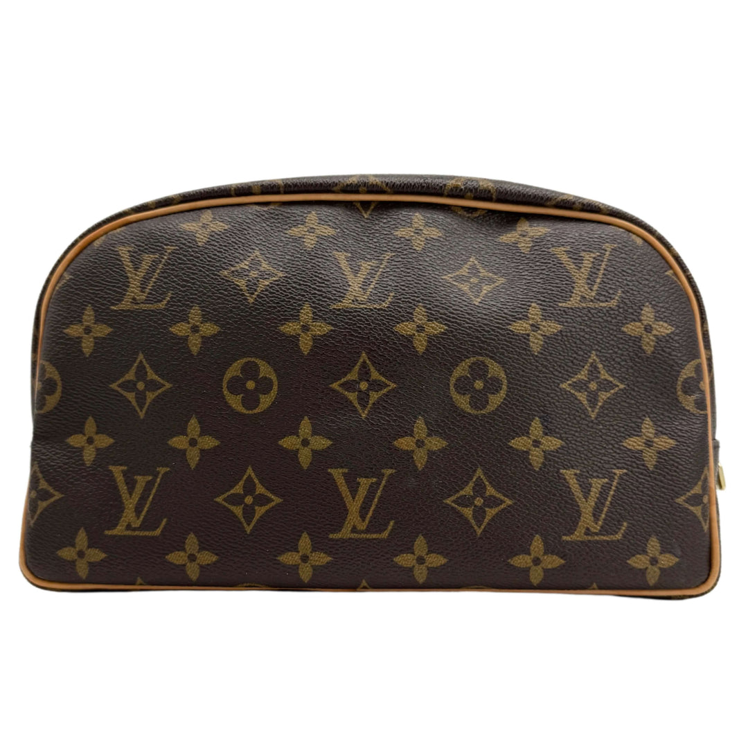 Louis Vuitton Monogram Toiletry Bag 25 in coated canvas with vachetta leather trim, stylish and functional travel essential.