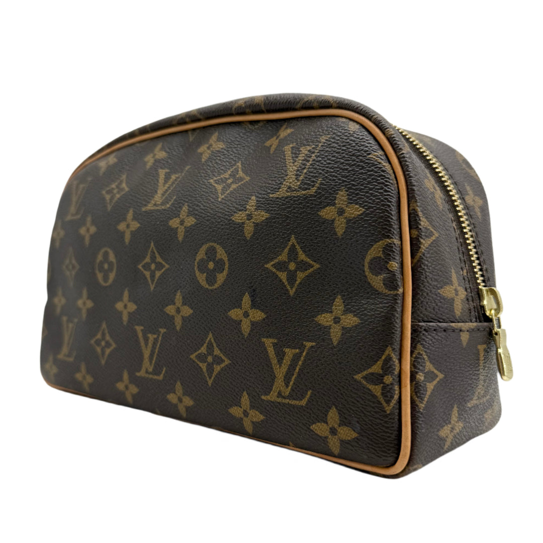 Louis Vuitton Monogram Toiletry Bag 25 in iconic canvas, featuring gold-tone zipper and vachetta leather trim.