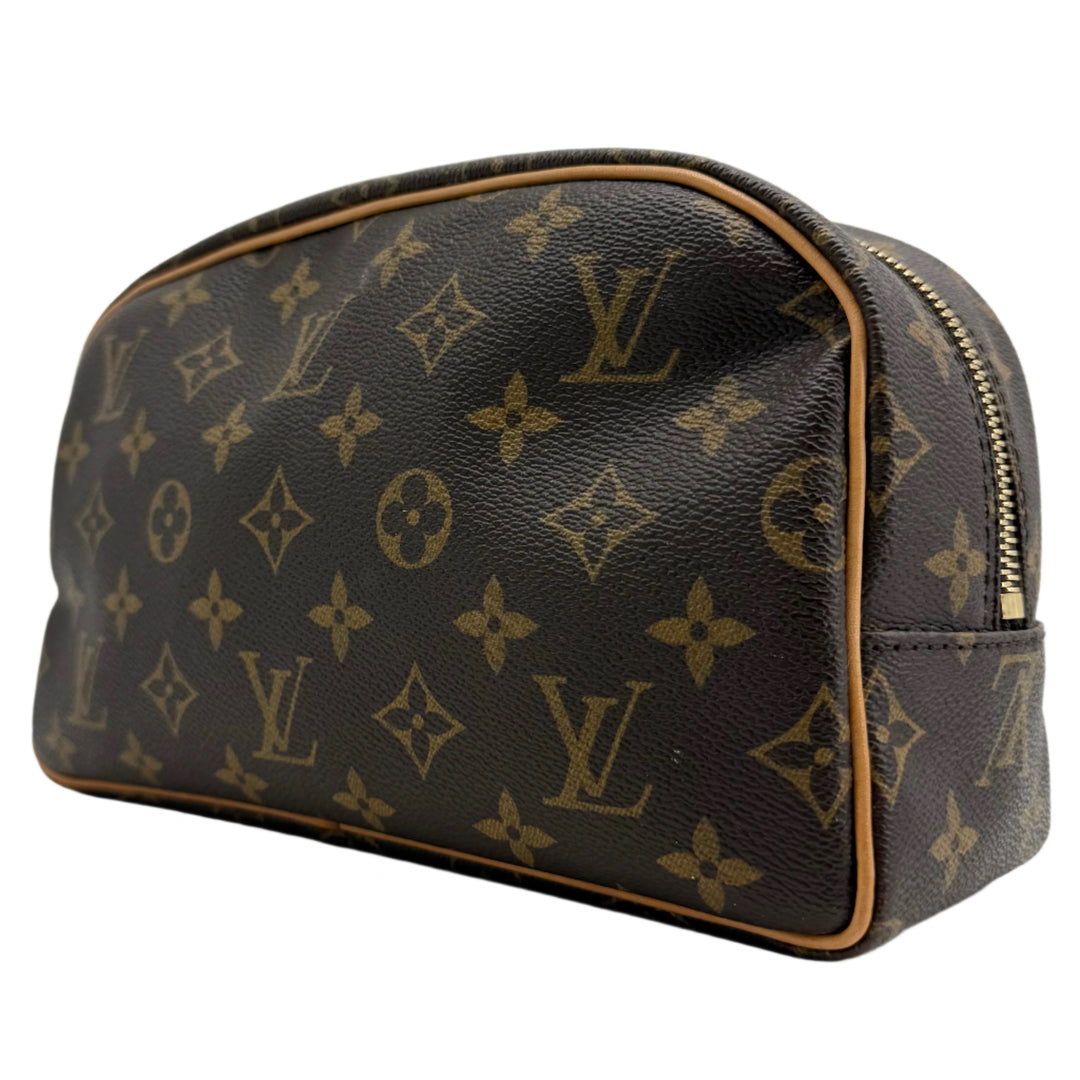 Louis Vuitton Monogram Toiletry Bag 25 in coated canvas with leather trim, ideal for elegant travel organization.