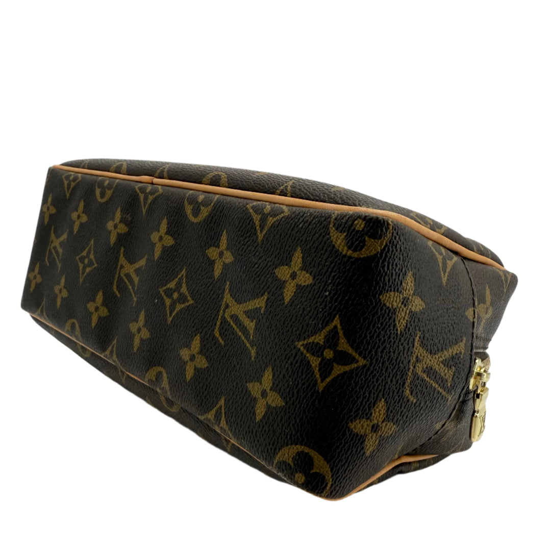 Louis Vuitton Monogram Toiletry Bag 25 in coated canvas, showcasing iconic monogram design and gold-tone zipper.