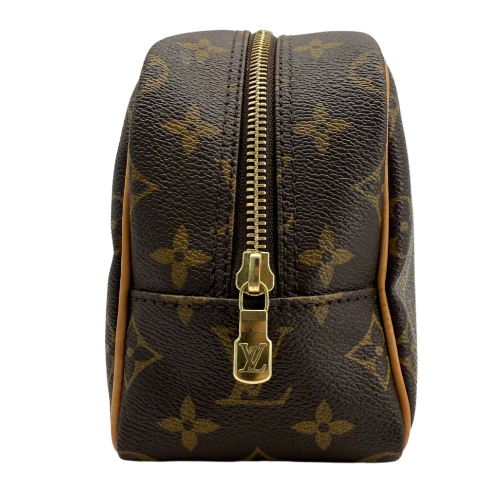 Louis Vuitton Monogram Toiletry Bag 25 showcasing classic coated canvas and gold-tone zipper detail.