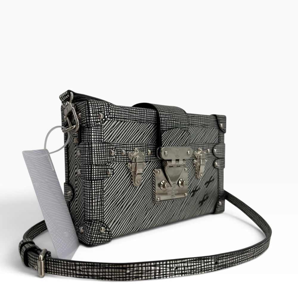 Louis Vuitton Petite Malle metallic silver-and-black trunk bag, angled front view showing corner trim and strap buckle