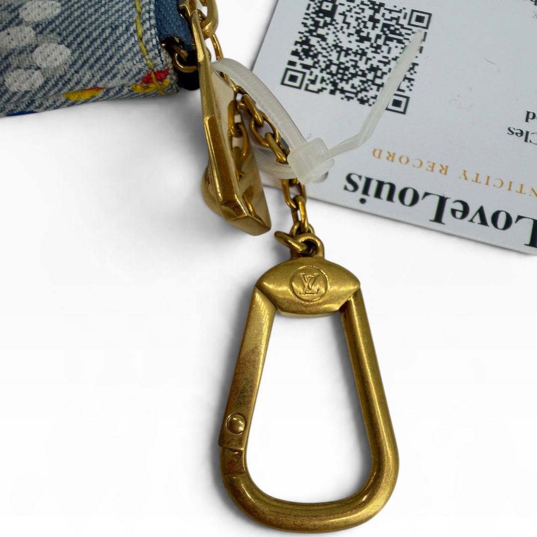 Close-up of gold-tone Louis Vuitton signature clasp and short key chain