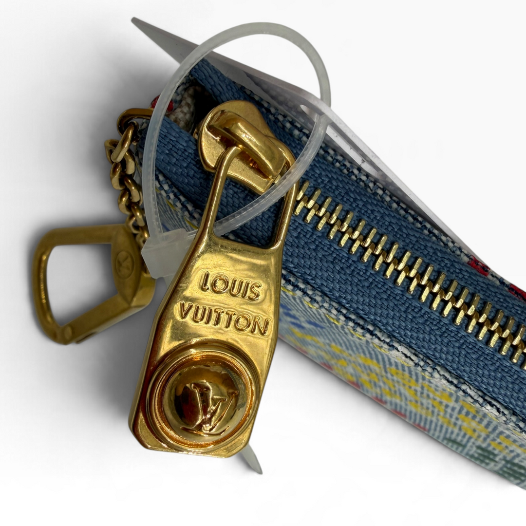 Detail of Louis Vuitton-engraved gold-tone zipper pull and blue denim zipper
