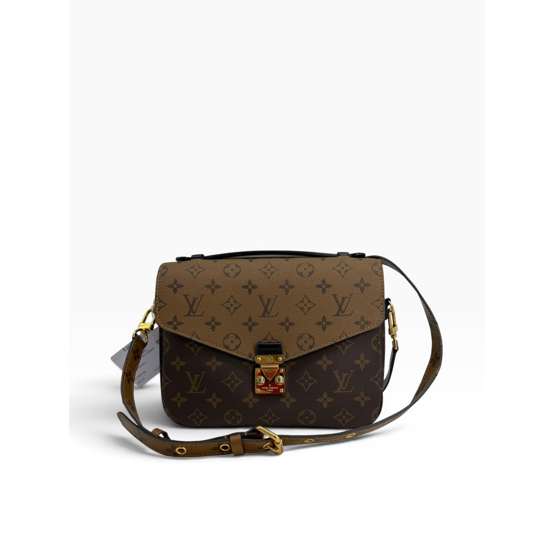 Front view of Louis Vuitton Pochette Metis in Monogram and Monogram Reverse canvas with shoulder strap