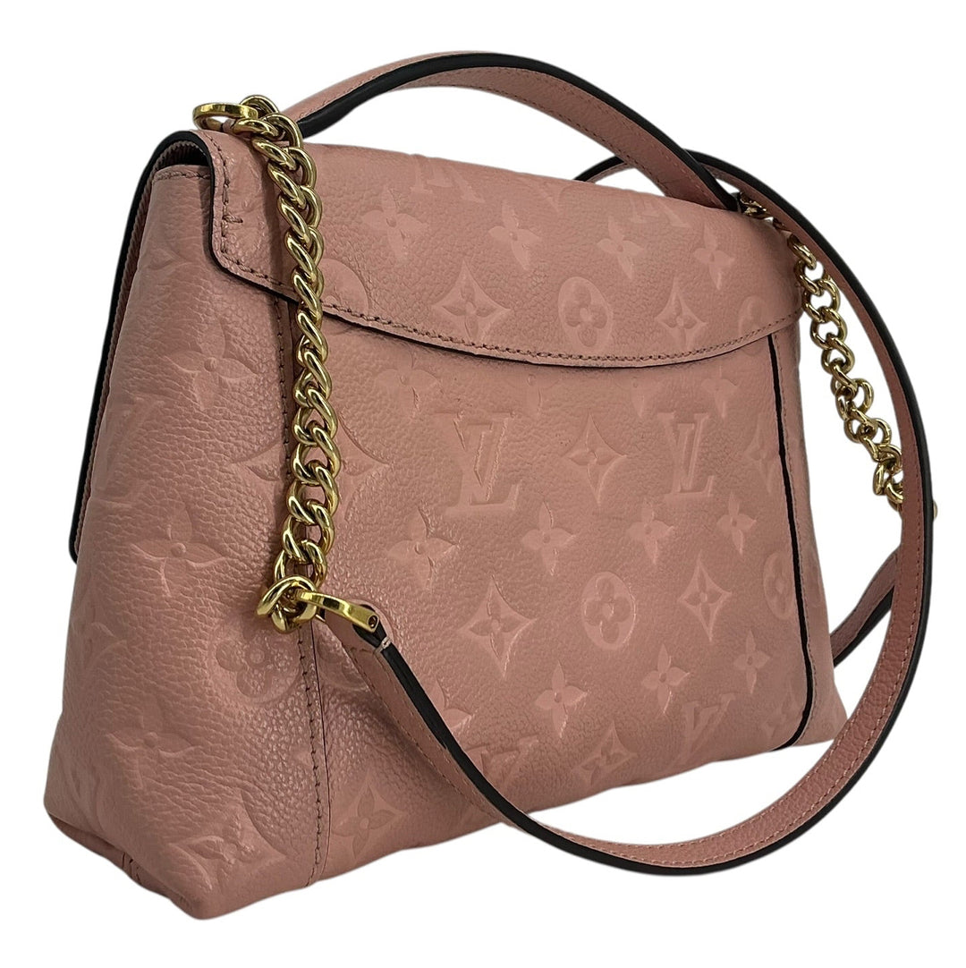 A Louis Vuitton shoulder bag in dusty pink monogram canvas with a gold chain link accent and a dark brown leather strap, shown on a plain white background.