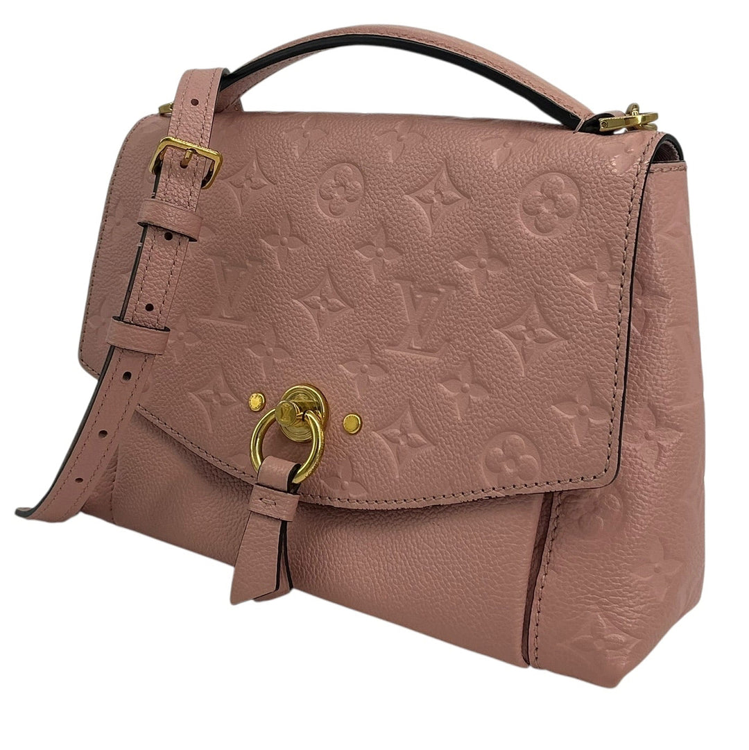 A Louis Vuitton monogram embossed leather handbag in a dusty rose pink color, featuring gold-tone hardware and a top handle, shown against a plain white background.