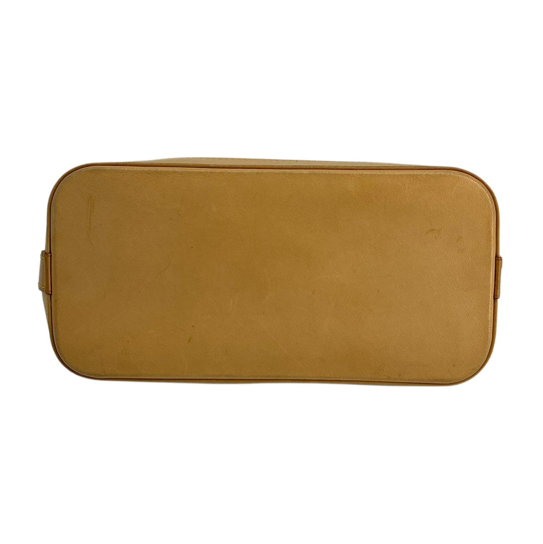 Louis Vuitton Lockit PM natural leather base showing patina surface marks and pre-owned wear