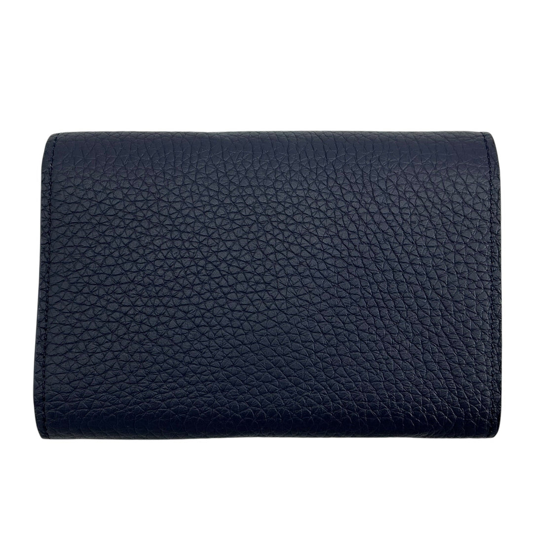 Back view of Louis Vuitton Capucines Compact navy leather wallet