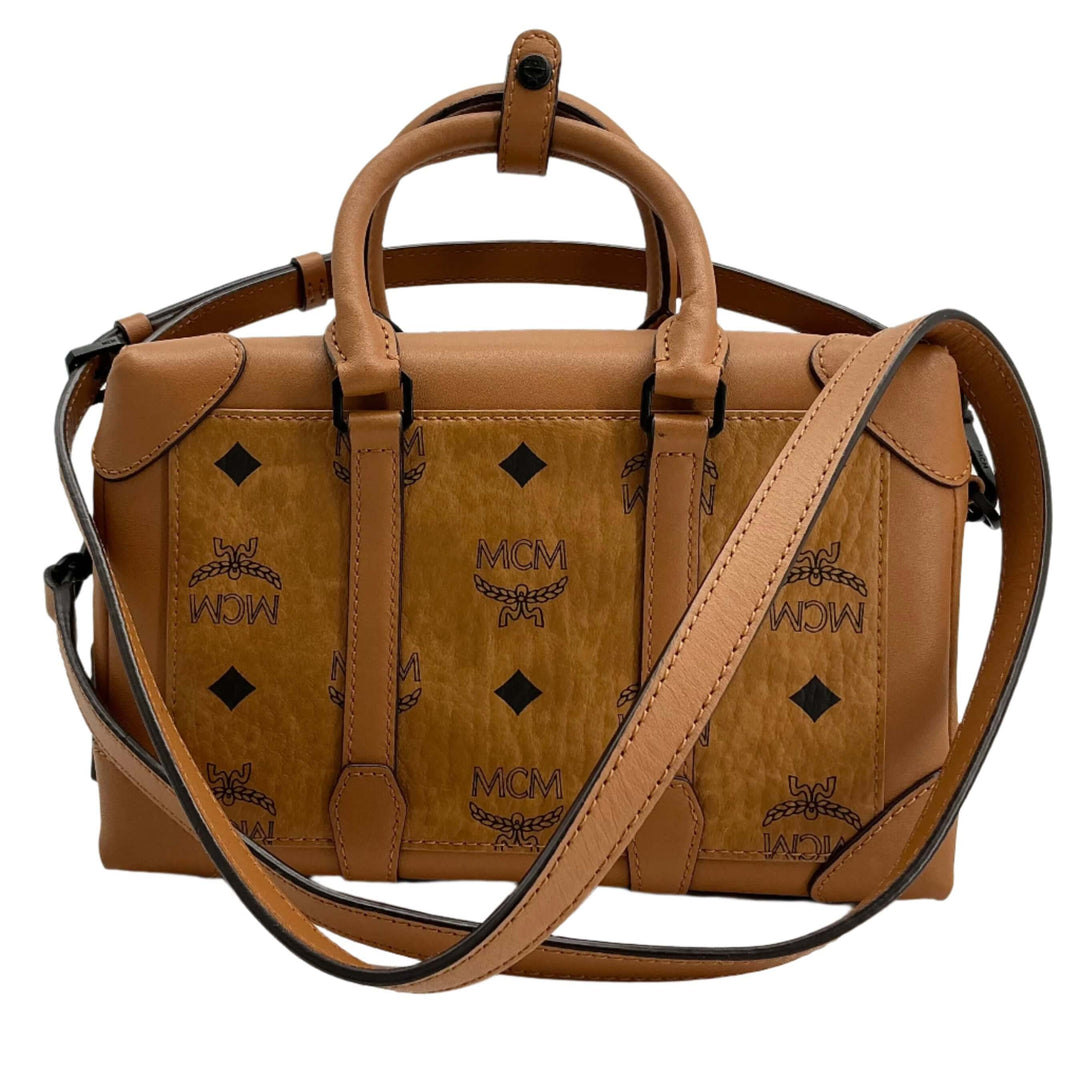 MCM handbag in tan, featuring iconic logo pattern and leather accents, ideal for stylish everyday use.
