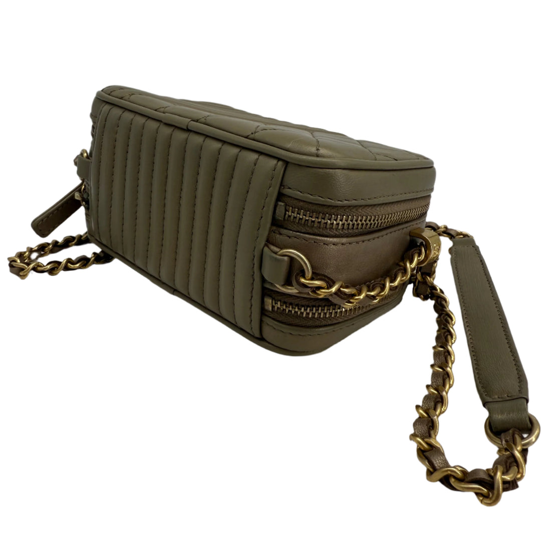 Olive green quilted leather shoulder bag with gold chain strap and zipper details, perfect for modern elegance.