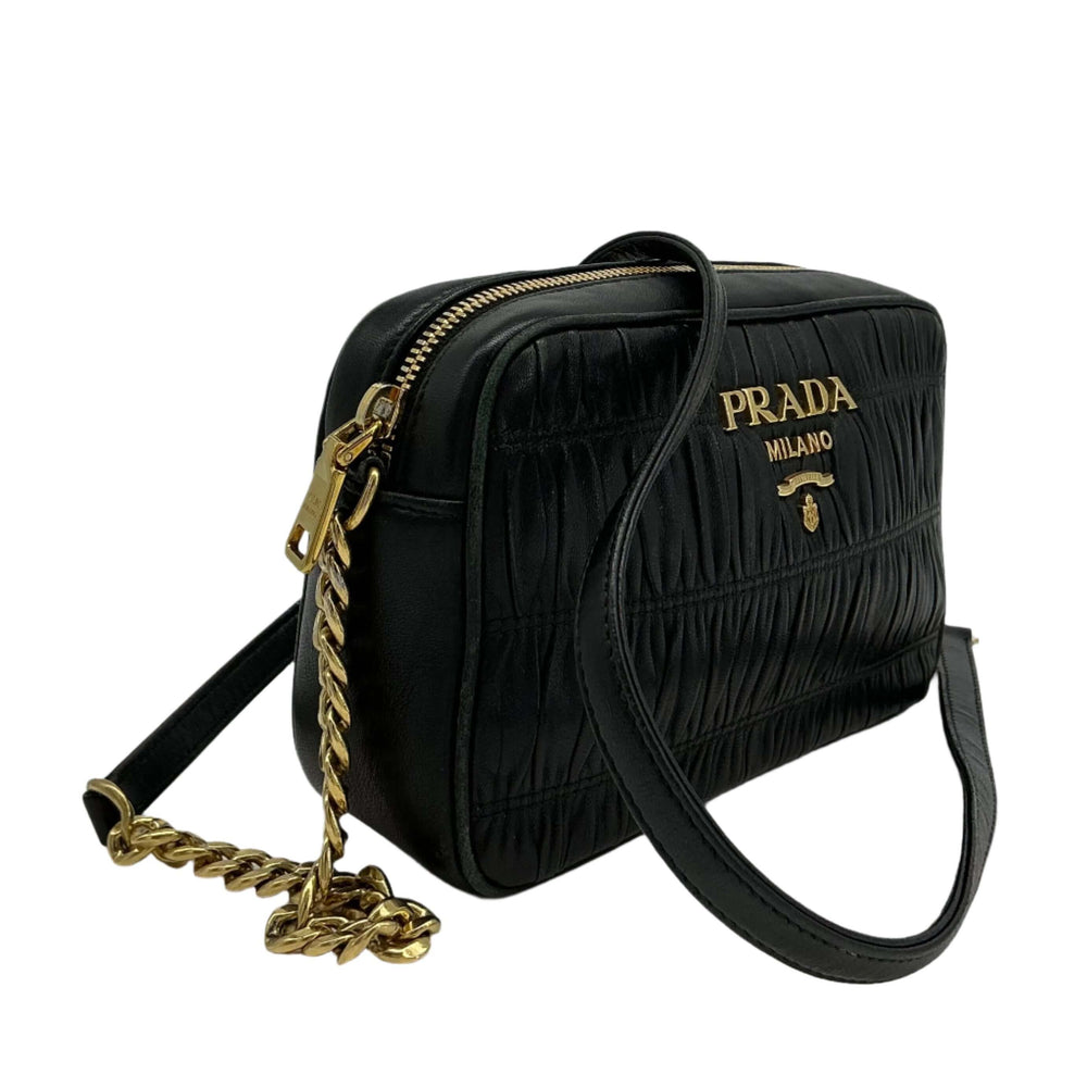 Prada Nappa Gaufre Camera Bag in black pleated lambskin leather with gold-tone chain strap.